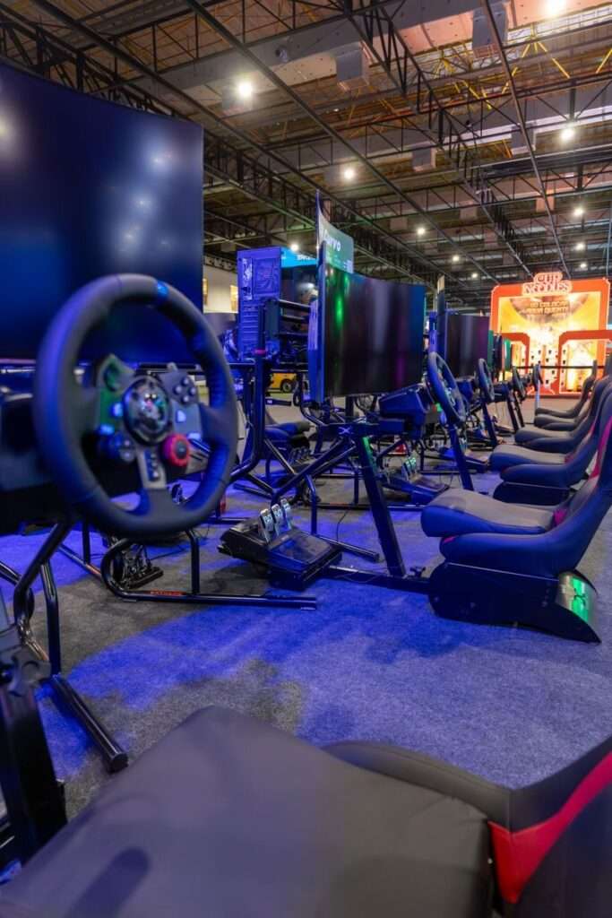 A modern setup of racing simulators in an indoor gaming arena with vibrant lighting.